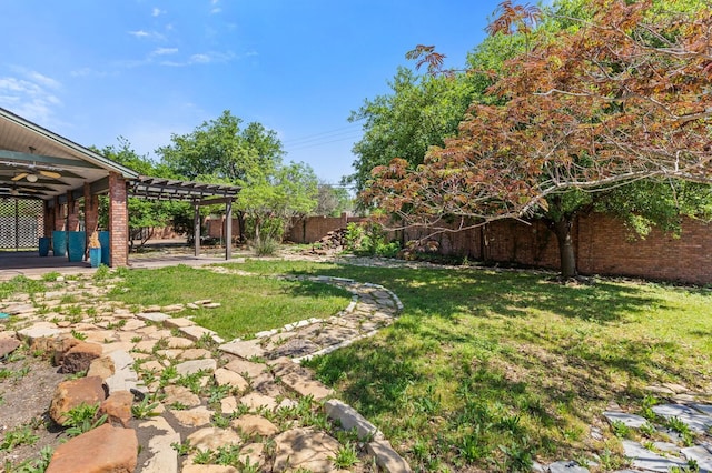 view of yard with a pergola, a patio area, a fenced backyard, and ceiling fan