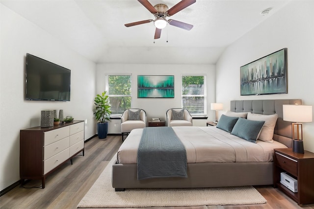 bedroom featuring ceiling fan, lofted ceiling, and wood finished floors