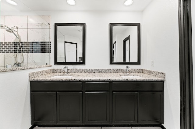 full bathroom with a sink, recessed lighting, double vanity, and tiled shower