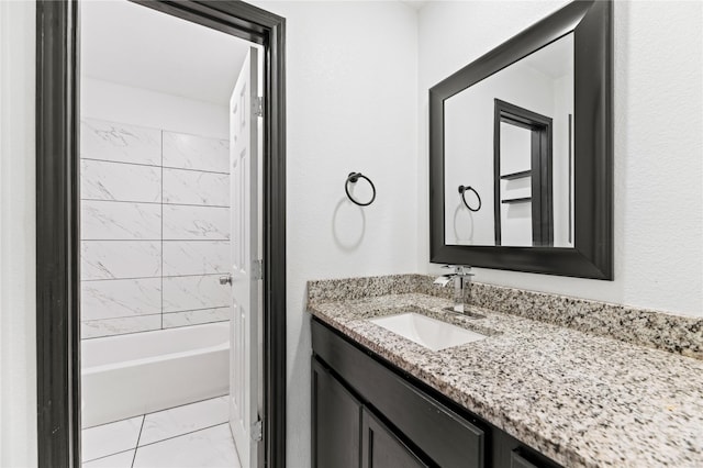 full bath featuring marble finish floor, vanity, and shower / bath combination