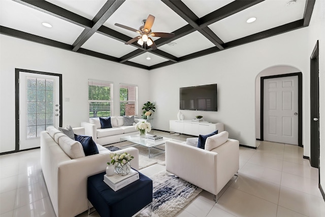 living room with a ceiling fan, light tile patterned floors, baseboards, coffered ceiling, and beam ceiling