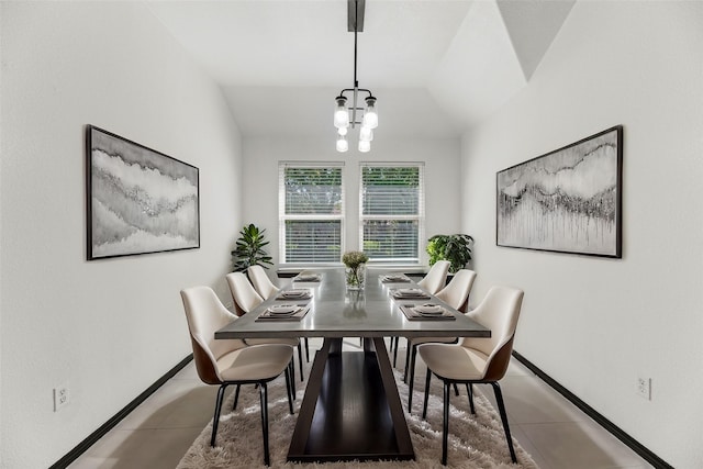 dining area featuring a chandelier, vaulted ceiling, tile patterned flooring, and baseboards