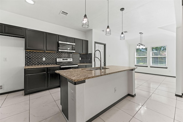 kitchen with a sink, tasteful backsplash, visible vents, stone countertops, and appliances with stainless steel finishes