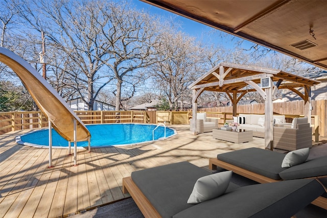 view of swimming pool featuring a fenced in pool, a fenced backyard, a gazebo, outdoor lounge area, and a deck
