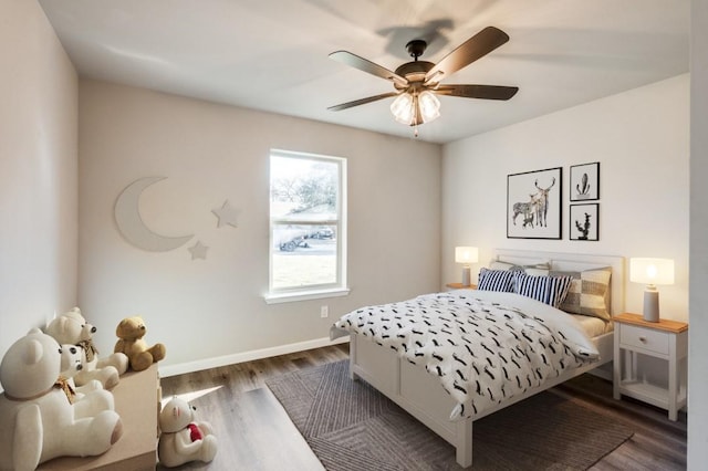 bedroom with baseboards, a ceiling fan, and dark wood-type flooring