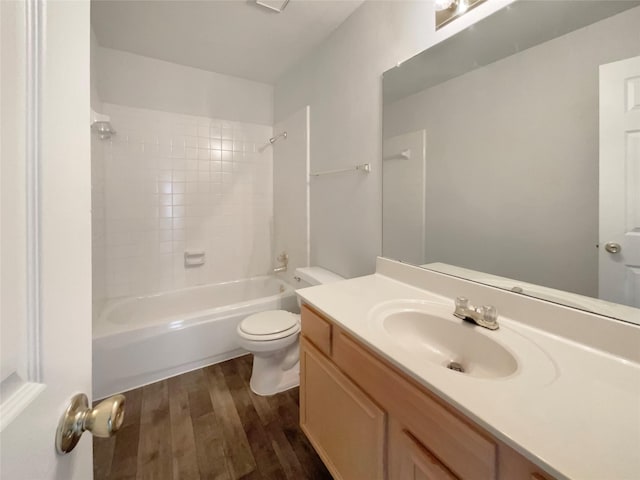 full bathroom featuring shower / bathtub combination, wood finished floors, vanity, and toilet