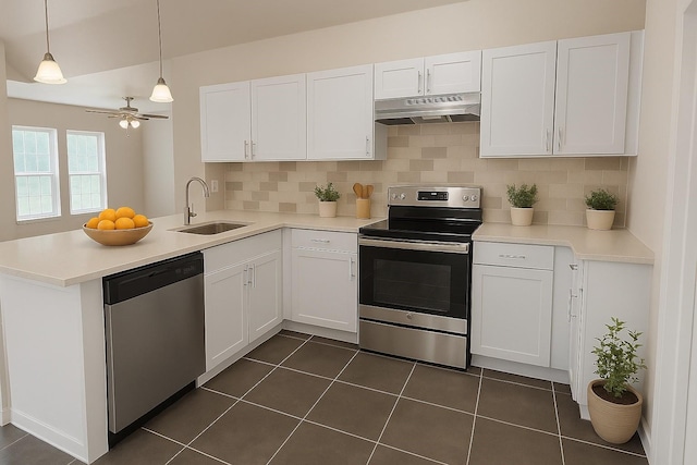 921 E Harvey Ave, Fort Worth, TX 76104 - kitchen featuring appliances with stainless steel finishes, under cabinet range hood, a sink, white cabinets, and a peninsula