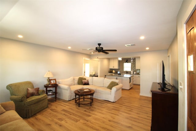 living area featuring recessed lighting, light wood-style floors, and ceiling fan
