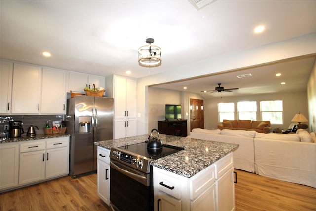 kitchen featuring white cabinets, light wood-style flooring, and appliances with stainless steel finishes