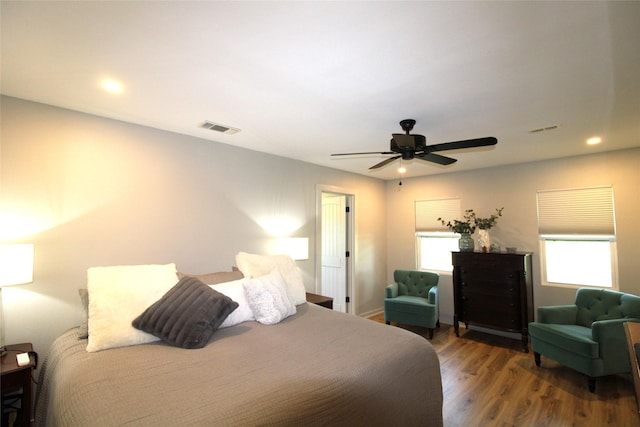 bedroom with ceiling fan, wood finished floors, visible vents, and recessed lighting