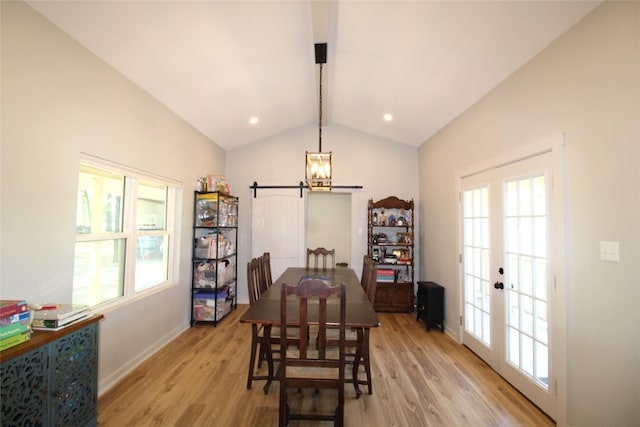 dining room with baseboards, a healthy amount of sunlight, vaulted ceiling with beams, and light wood-style floors