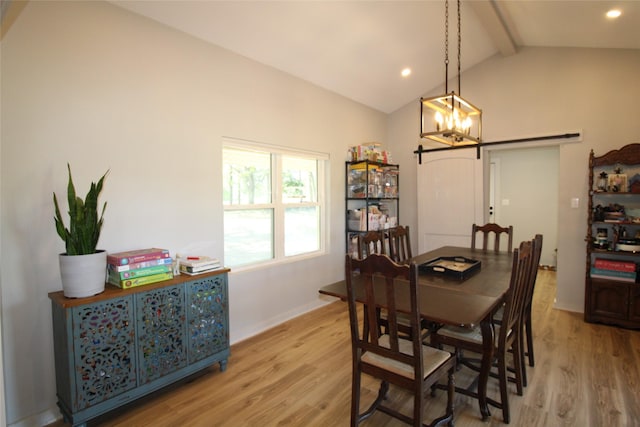 dining space with a barn door, recessed lighting, an inviting chandelier, light wood-style floors, and lofted ceiling with beams