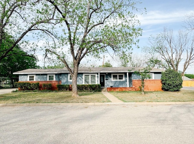 ranch-style house with brick siding and a front yard