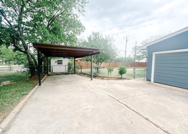 view of car parking featuring concrete driveway and fence