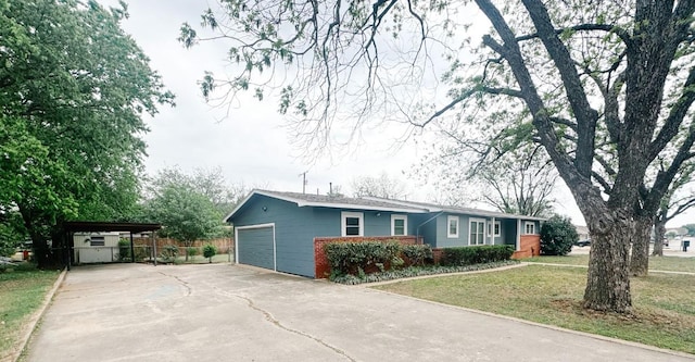 ranch-style home featuring a front lawn, driveway, fence, a garage, and brick siding