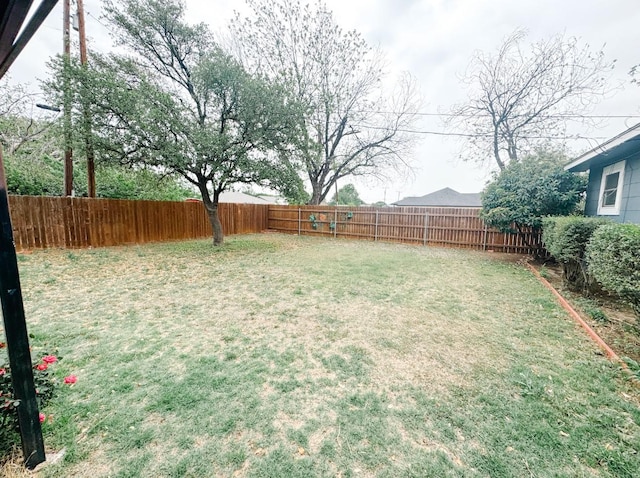 view of yard with a fenced backyard