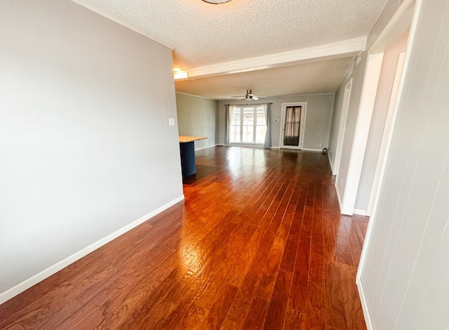 unfurnished room featuring baseboards, a textured ceiling, ceiling fan, and dark wood-style flooring