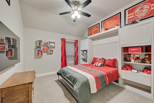 carpeted bedroom with vaulted ceiling, a ceiling fan, and baseboards