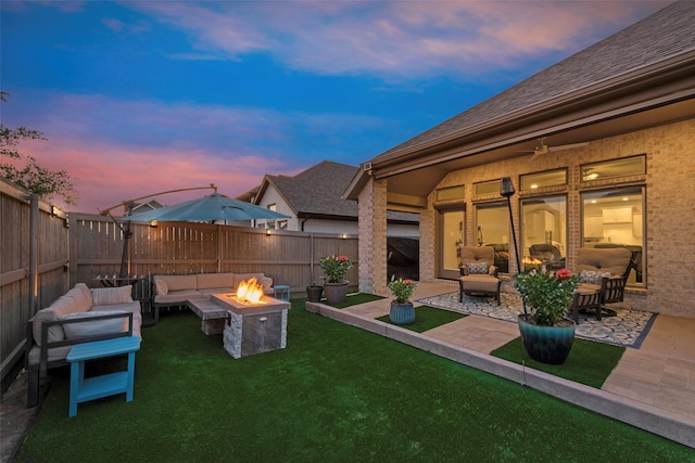 view of yard featuring a patio area, an outdoor living space with a fire pit, and a fenced backyard