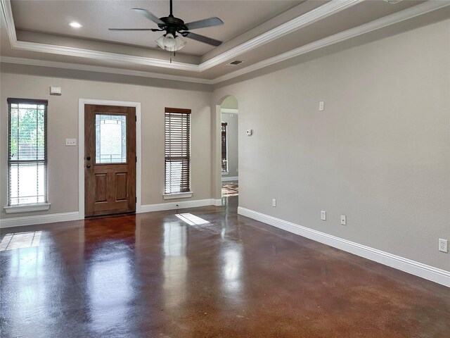 1114 N Elm St, Weatherford, TX 76086 - foyer entrance with concrete floors, a tray ceiling, a ceiling fan, arched walkways, and crown molding
