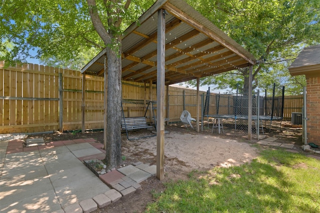 807-809 Sun Valley Dr, Denton, TX 76209 - view of yard with a fenced backyard, central AC unit, a patio area, and a trampoline