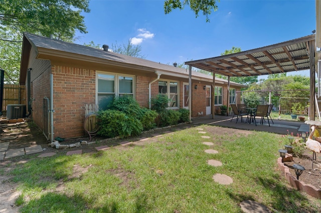 807-809 Sun Valley Dr, Denton, TX 76209 - rear view of property featuring fence, a yard, cooling unit, a patio area, and brick siding