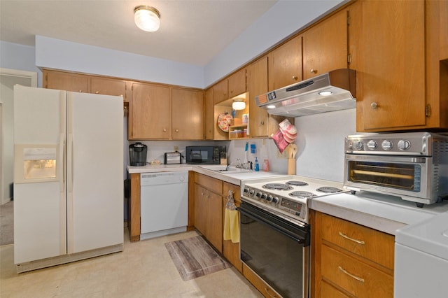 807-809 Sun Valley Dr, Denton, TX 76209 - kitchen with under cabinet range hood, light countertops, white appliances, and a sink