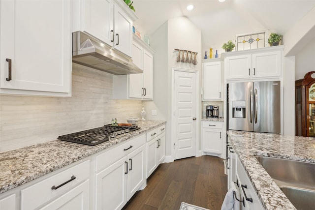 3204 Discovery Dr, Little Elm, TX 75068 - kitchen with stainless steel appliances, under cabinet range hood, white cabinets, backsplash, and dark wood-type flooring