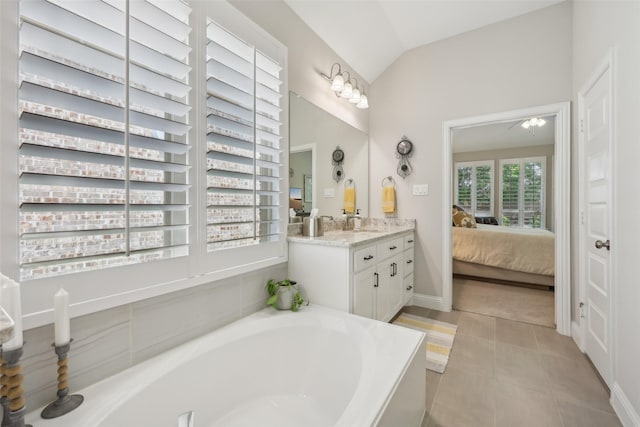 3204 Discovery Dr, Little Elm, TX 75068 - ensuite bathroom featuring vanity, a garden tub, lofted ceiling, and tile patterned floors