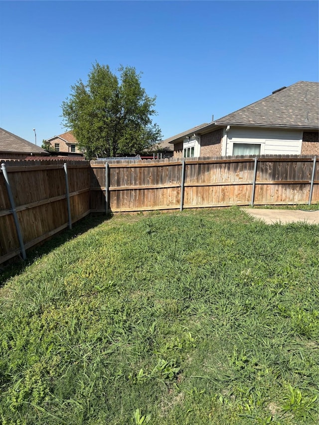 view of yard with a fenced backyard