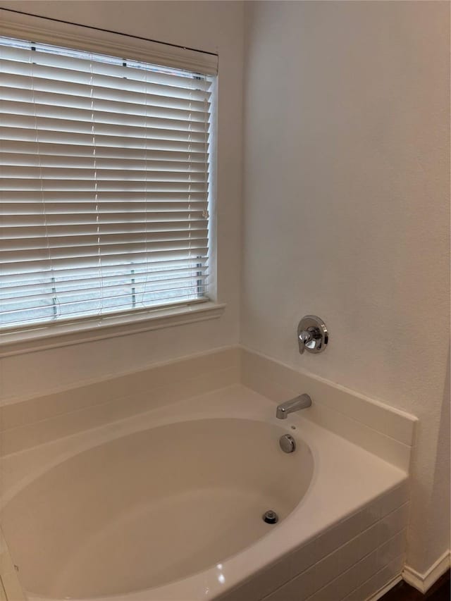 full bathroom with a bath