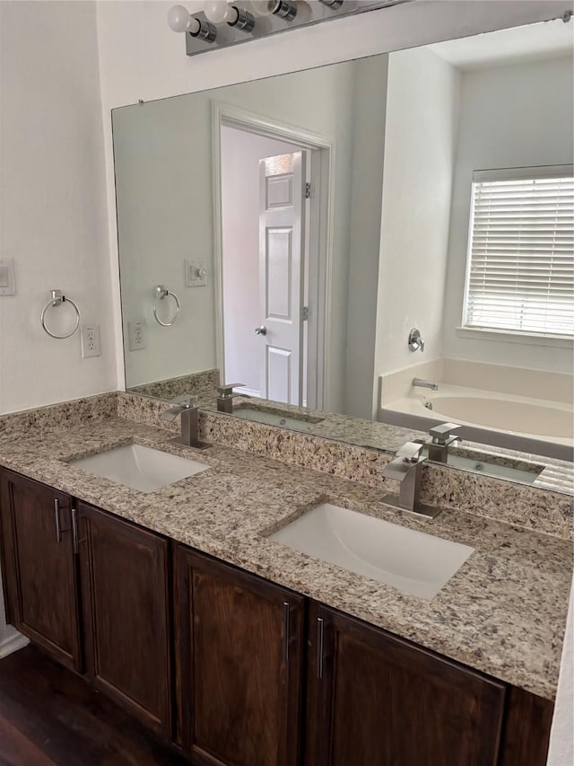 bathroom featuring a sink and double vanity