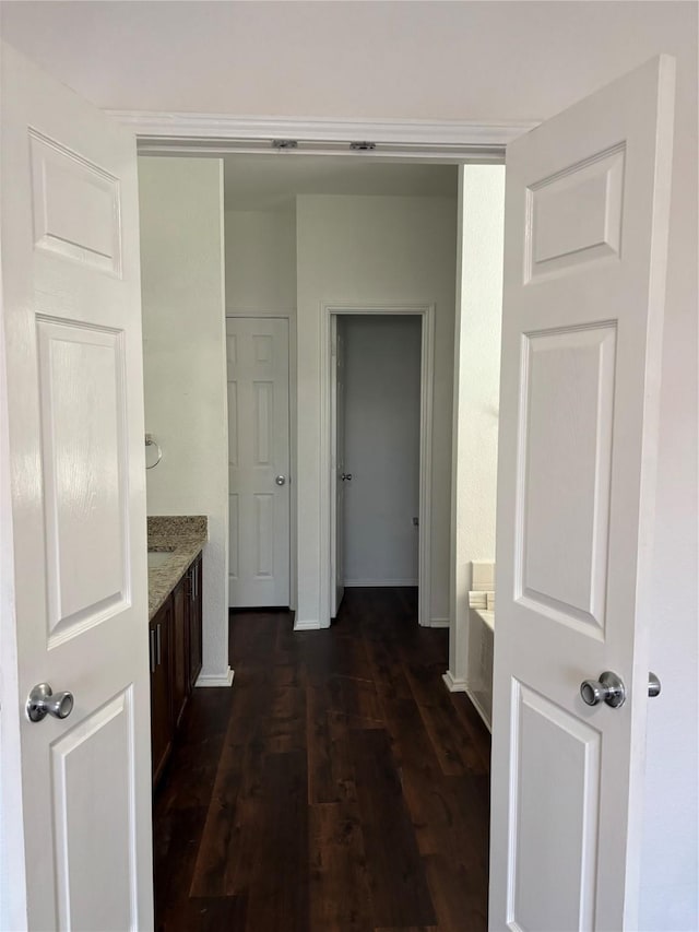 corridor with dark wood-style floors