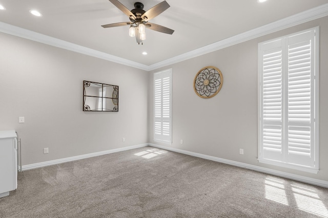 carpeted spare room featuring baseboards, ornamental molding, recessed lighting, and ceiling fan