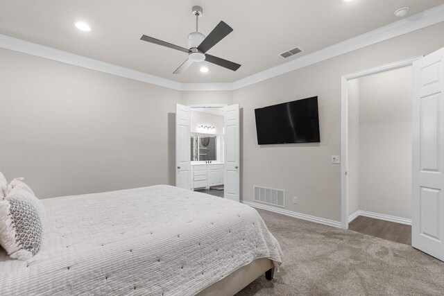 carpeted bedroom featuring visible vents, baseboards, and ornamental molding