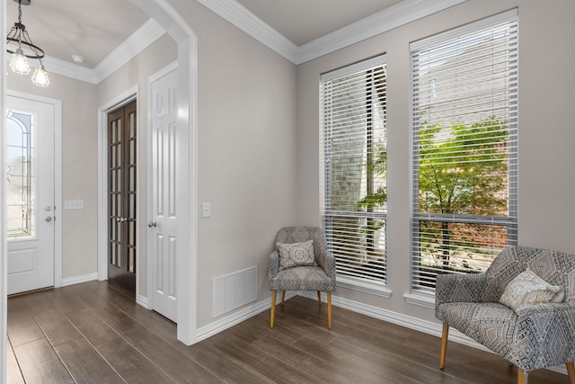 sitting room with dark wood finished floors, arched walkways, a healthy amount of sunlight, and visible vents