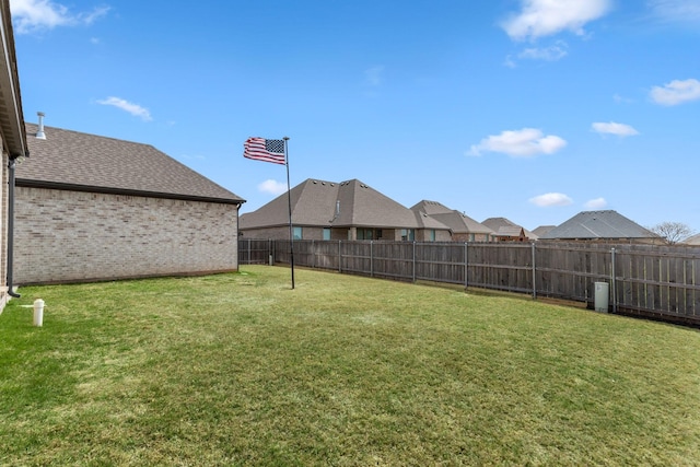 view of yard with a fenced backyard and a residential view