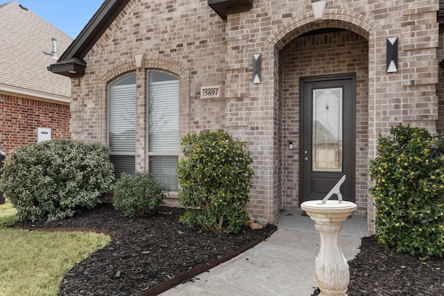 property entrance with brick siding