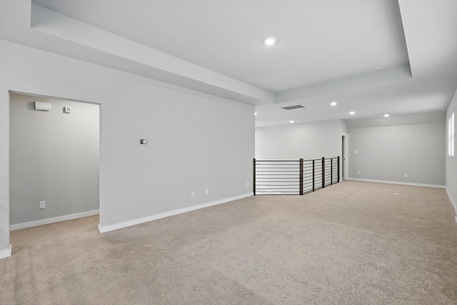spare room with visible vents, recessed lighting, light carpet, and baseboards
