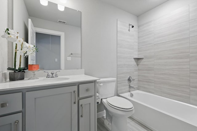 full bathroom featuring toilet, visible vents, vanity, and bathing tub / shower combination