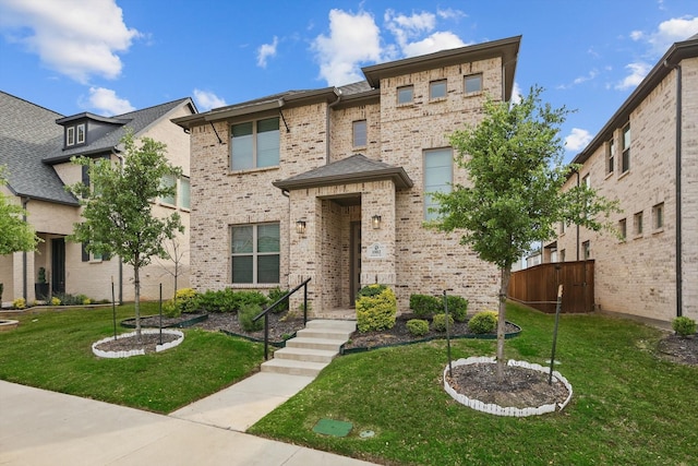 view of front of home featuring brick siding and a front yard