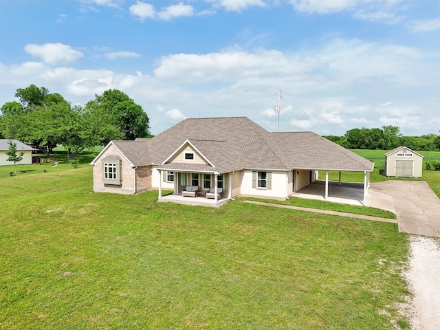 108 N Westlake Dr, Leonard, TX 75452 - rear view of property with driveway, a lawn, an outbuilding, a storage unit, and a carport