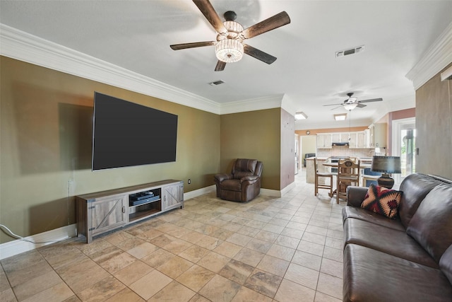 living area featuring visible vents, a ceiling fan, baseboards, and ornamental molding