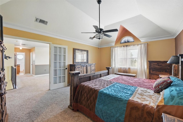 carpeted bedroom featuring lofted ceiling, visible vents, ceiling fan, and crown molding