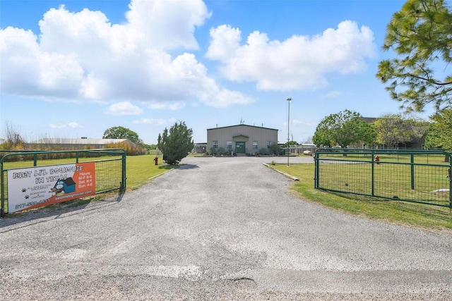 view of road with aphalt driveway and a gated entry