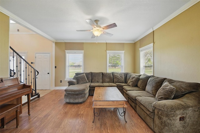 living room featuring stairway, wood finished floors, a ceiling fan, ornamental molding, and baseboards
