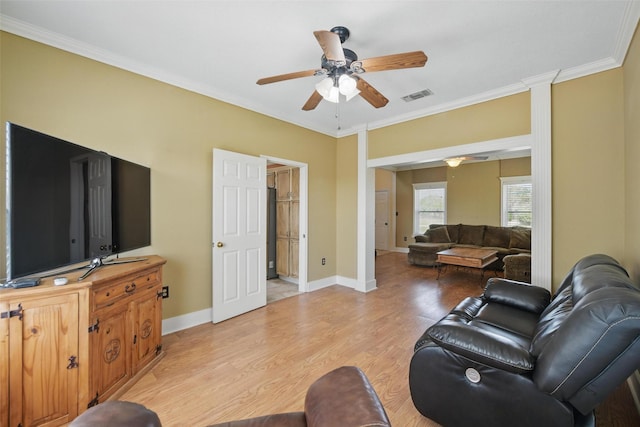 living area with ceiling fan, light wood-style flooring, baseboards, ornamental molding, and visible vents