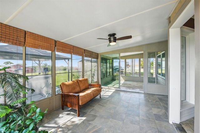 sunroom / solarium with a ceiling fan and a healthy amount of sunlight