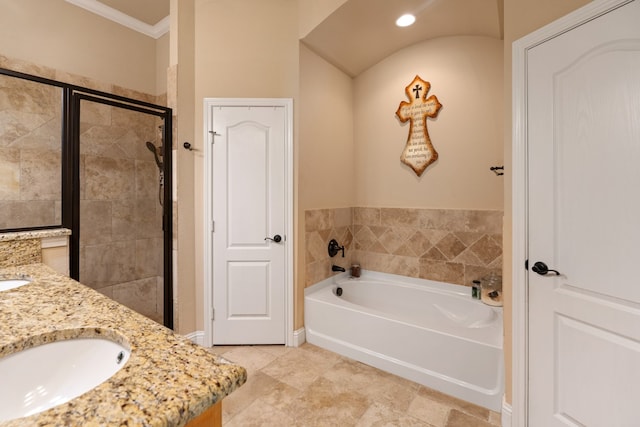 full bath with double vanity, ornamental molding, a sink, a bath, and a stall shower