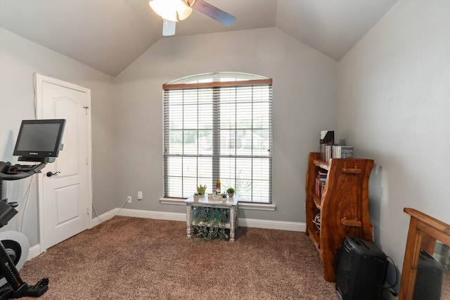 interior space with ceiling fan, vaulted ceiling, carpet floors, and baseboards